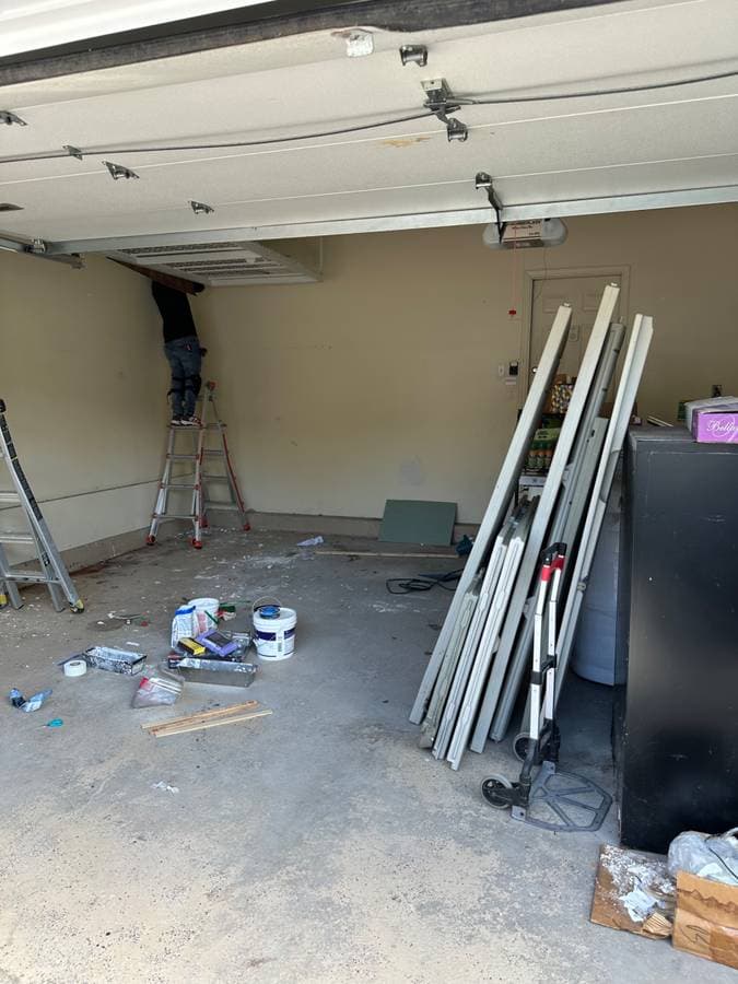picture of a garage in long island new york being remodeled with  new paint and garage doors